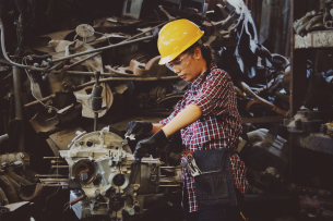 woman working on a mecanical industrial work