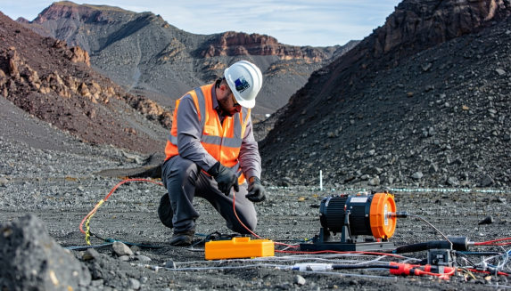 A geophysicist setting up seismic equipment 