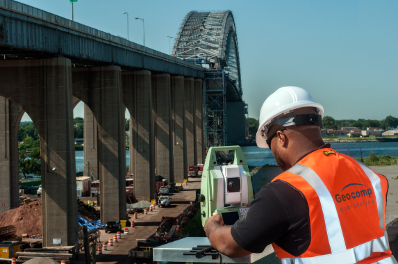 Man in the field monitoring a bridge